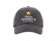 A black baseball cap with 'Mellow Johnny's Bike Shop' logo and a yellow star embroidered on the front.