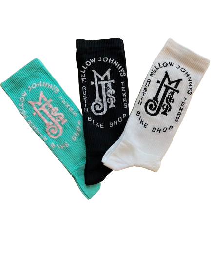 Three socks laid out flat with different colors and logos. One is black with a white logo, one is white with a black logo, and one is a solid teal color.