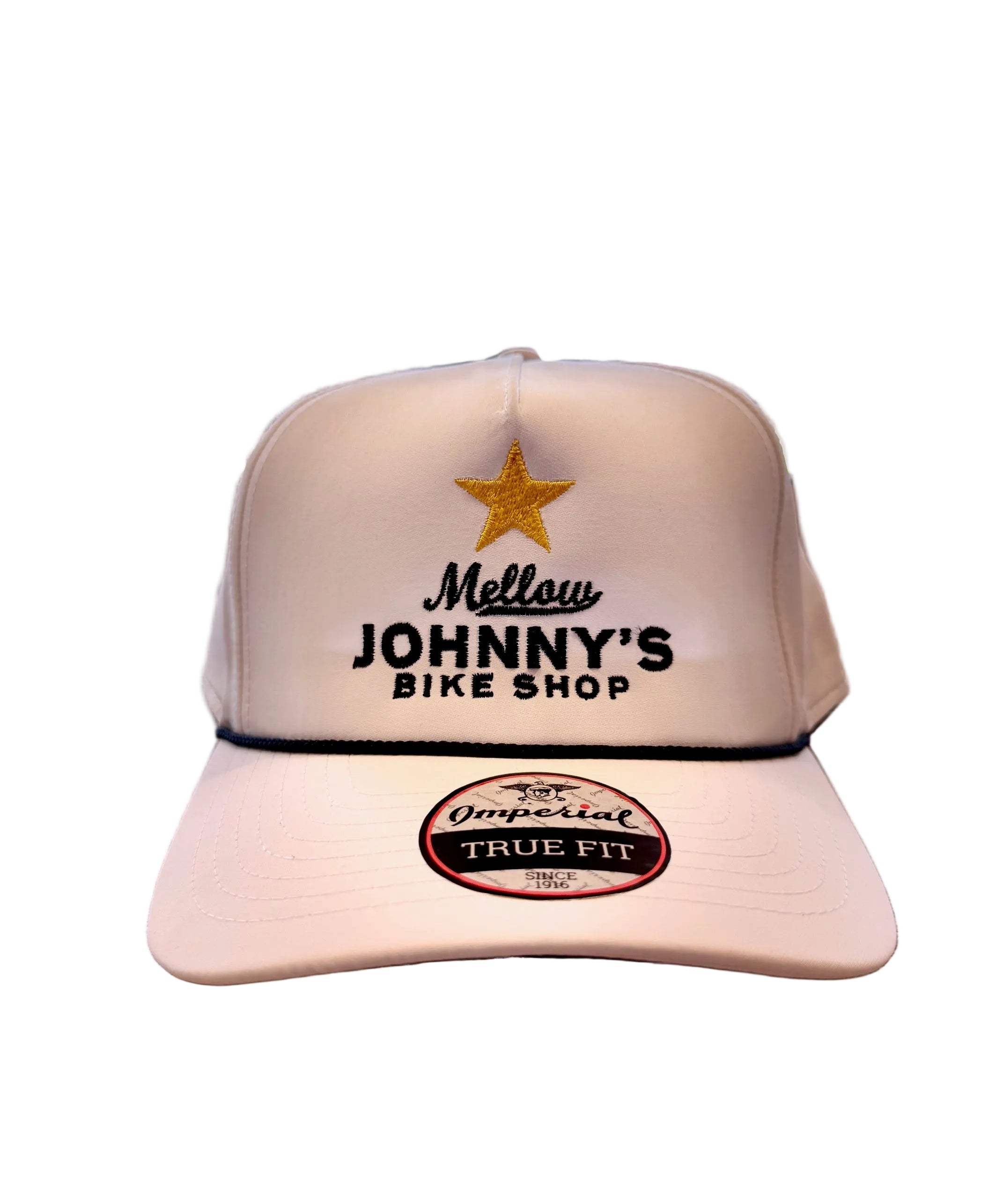 White cap with 'Mellow Johnny's Bike Shop' logo on a wooden surface with bicycles in the background